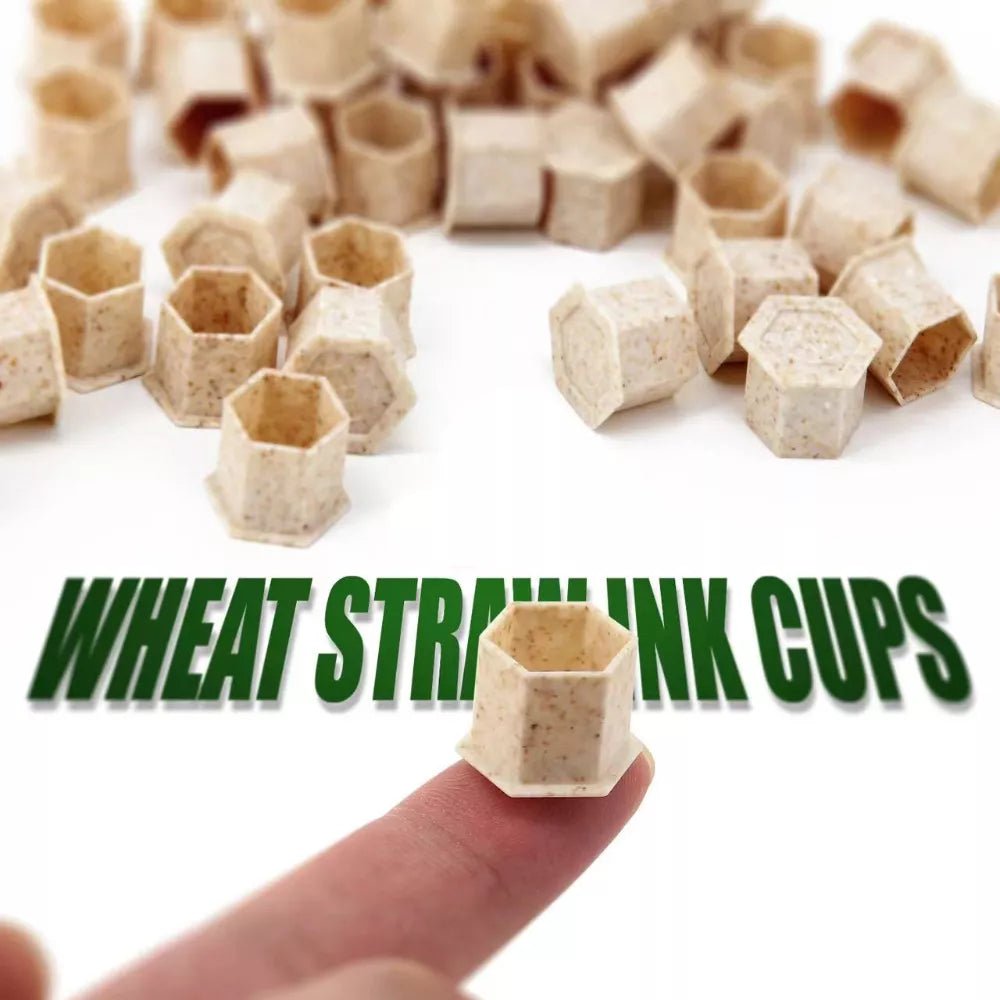 Wheat straw ink cups with a hand holding one for scale on a white background