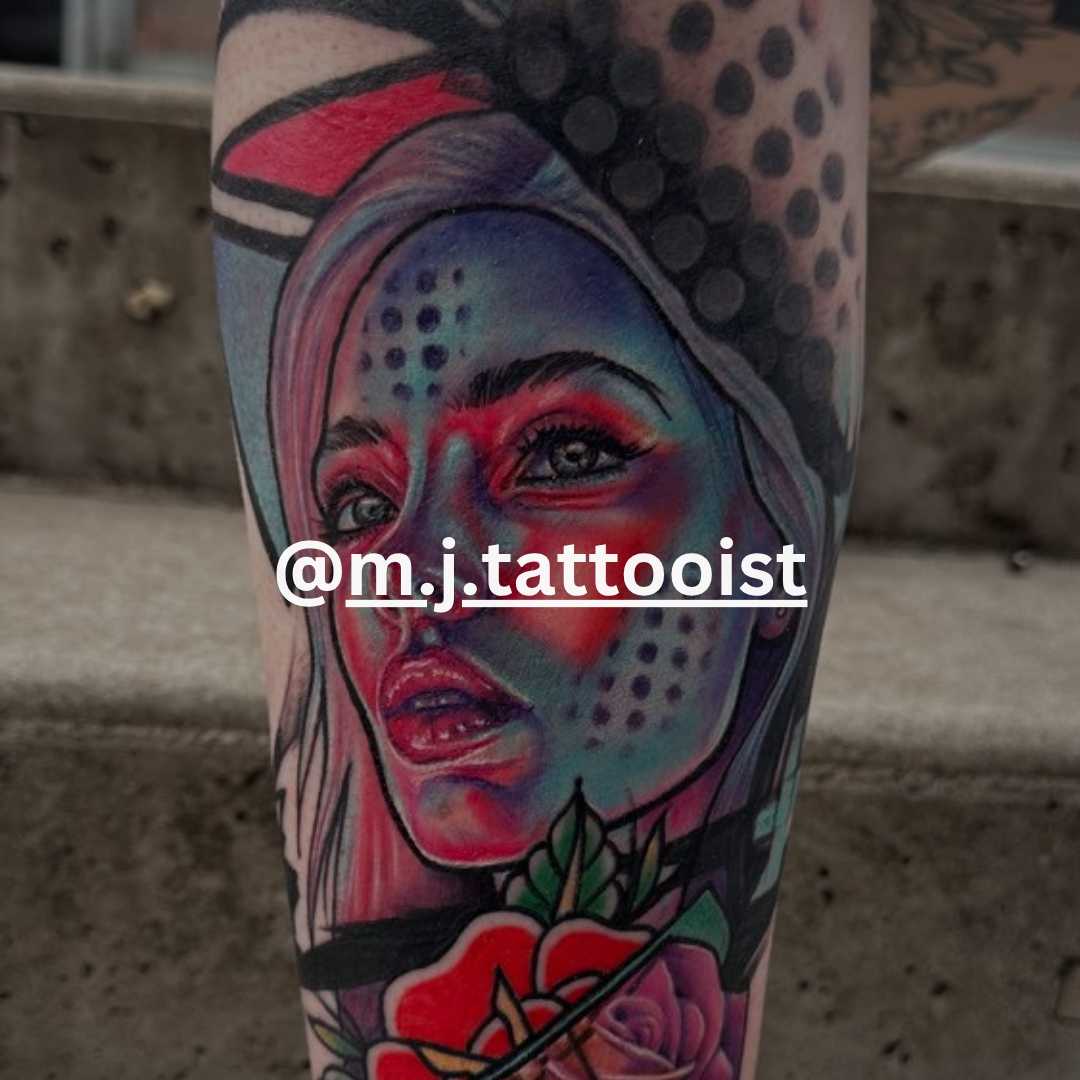Colorful tattoo of a woman's face with geometric patterns on a person's leg, blurred background.