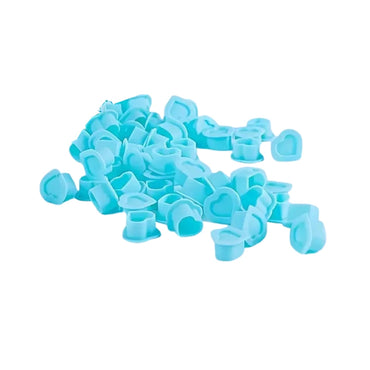 Blue silicone heart shaped ink cups scattered on a white background