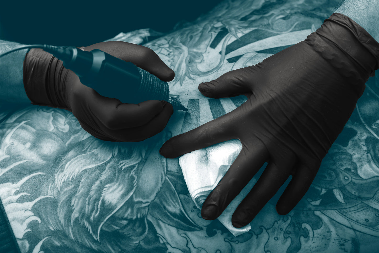 Tattoo Artists using Black nitrile gloves from unigloves