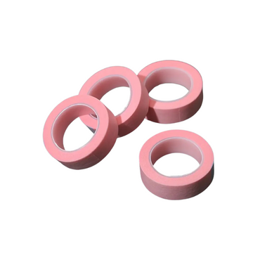 Four rolls of Pink microporous tape on a white background