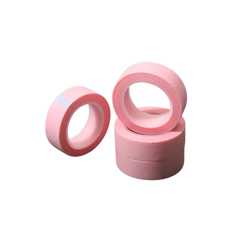 Pink microporous tape rolls stacked on a white background