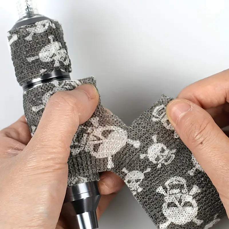 Skull tattoo grip tape applied to a tattoo machine