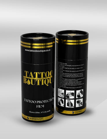 Two black cylindrical containers with gold accents labeled 'Tattoo Boutique' on a light gray background.