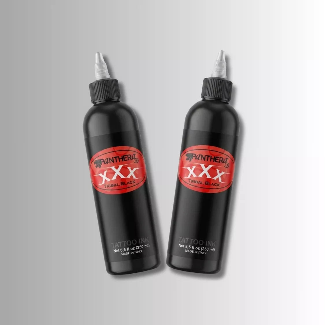 Two Panthera XXX Tribal Black tattoo ink 250ml bottles with white nozzle caps, featuring red and black Panther Ink XXX branding, displayed on a light gray gradient background.