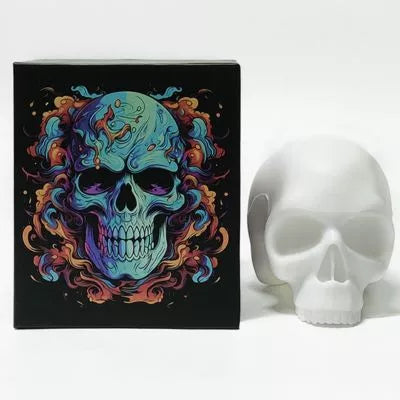 A white boxed skull tattoo practice model for studio display, which features a colorful, vibrant skull illustration with blue, purple, orange, and red tones.