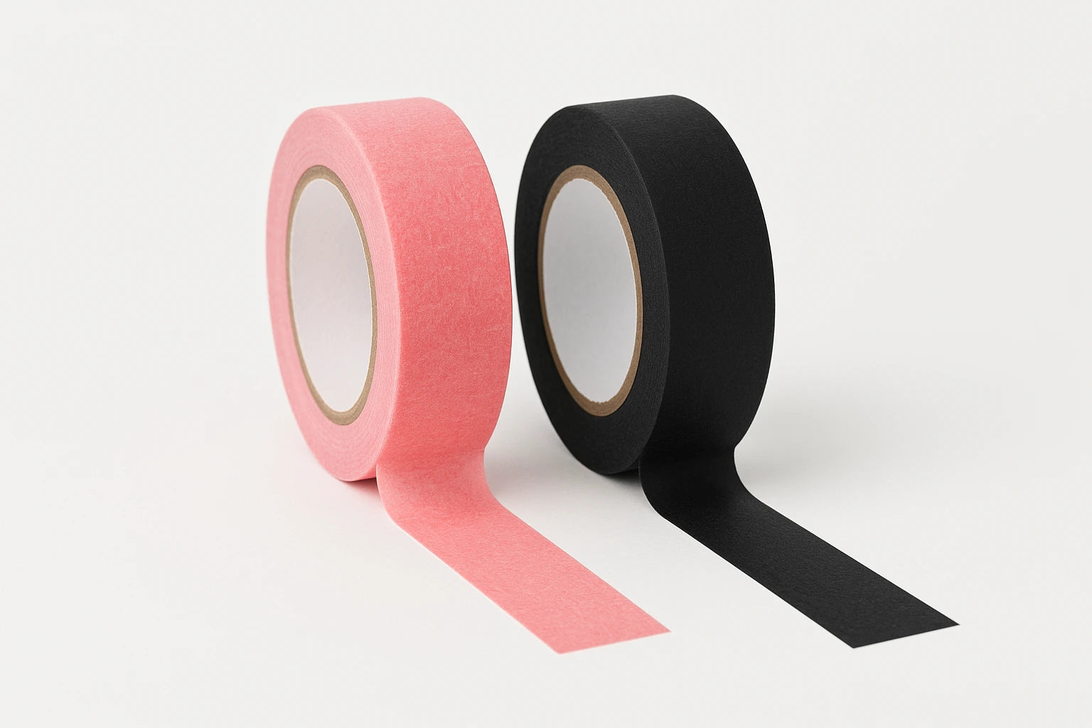 Two rolls of tatto paper tape, one pink and one black, on a white background