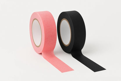 Two rolls of tatto paper tape, one pink and one black, on a white background