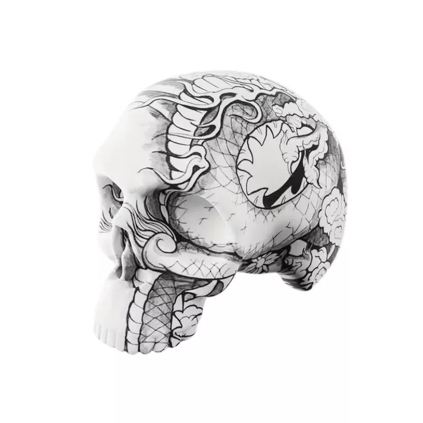 A Soft silicone tattoo practice skin for linework and shading with black and white tattoo of dragon-like scales and ornate decorative linework, shown on a plain white background.