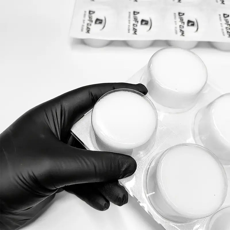 Hand holding Dip Foam needle cleaning cup