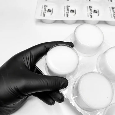 Hand holding Dip Foam needle cleaning cup