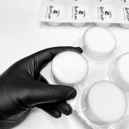 Hand holding Dip Foam needle cleaning cup