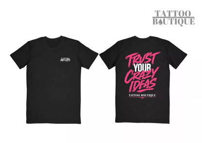 Two black short-sleeve T-shirts shown against a white background, displaying the front and back designs. The front shirt features a small white 'TATTOO BOUTIQUE' logo on the left chest.