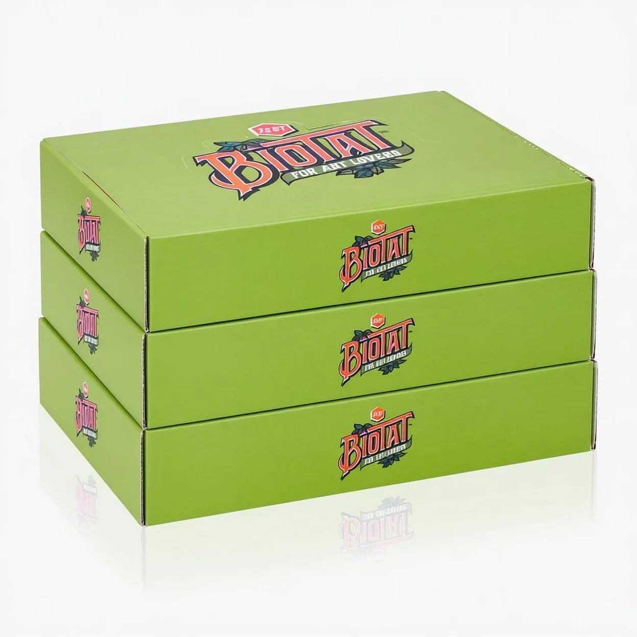 Three stacked lime green retail display boxes of Biotat Zest tattoo butter for studios on a clean white background with a soft reflection underneath