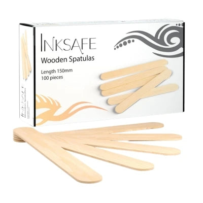 A box of Inksafe Wooden Spatulas with several light natural wood spatulas displayed in front on a white 