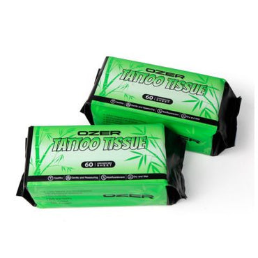 Two packs of Ozer Tattoo Tissue Wipes, featuring bright green packaging with black edges and white text, set against a plain white background.