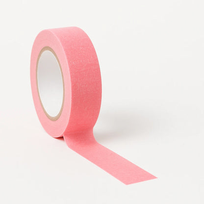 Pink tattoo paper tape roll on a white background