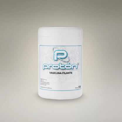 A white plastic jar of Protón Vaseline Filante (petroleum jelly) with a white and blue label, set against a neutral gray gradient background.