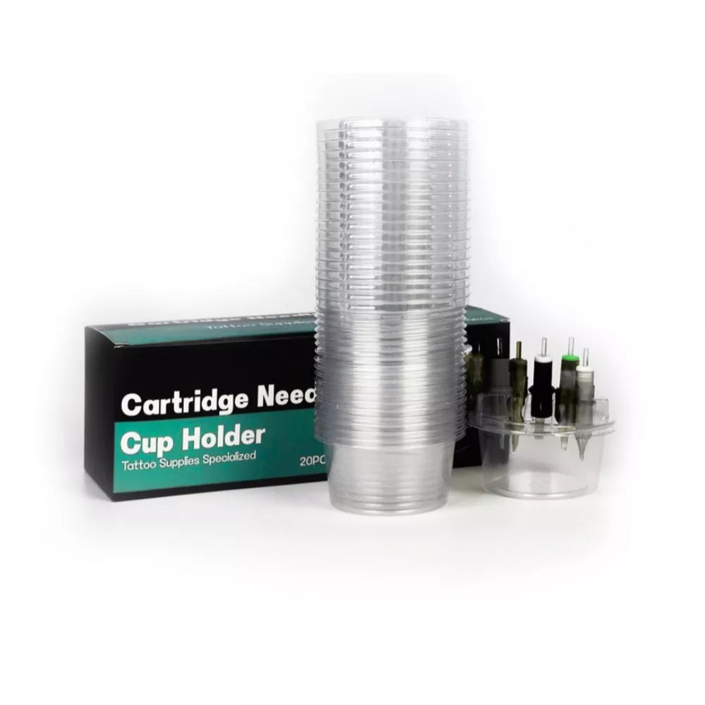 A stack of clear plastic tattoo needle cartridge cup holders stands in front of a black and teal product box labeled 'Cartridge Needle Cup Holder Tattoo Supplies Specialized 20PC'. To the right is a small clear cup holding several tattoo cartridges.