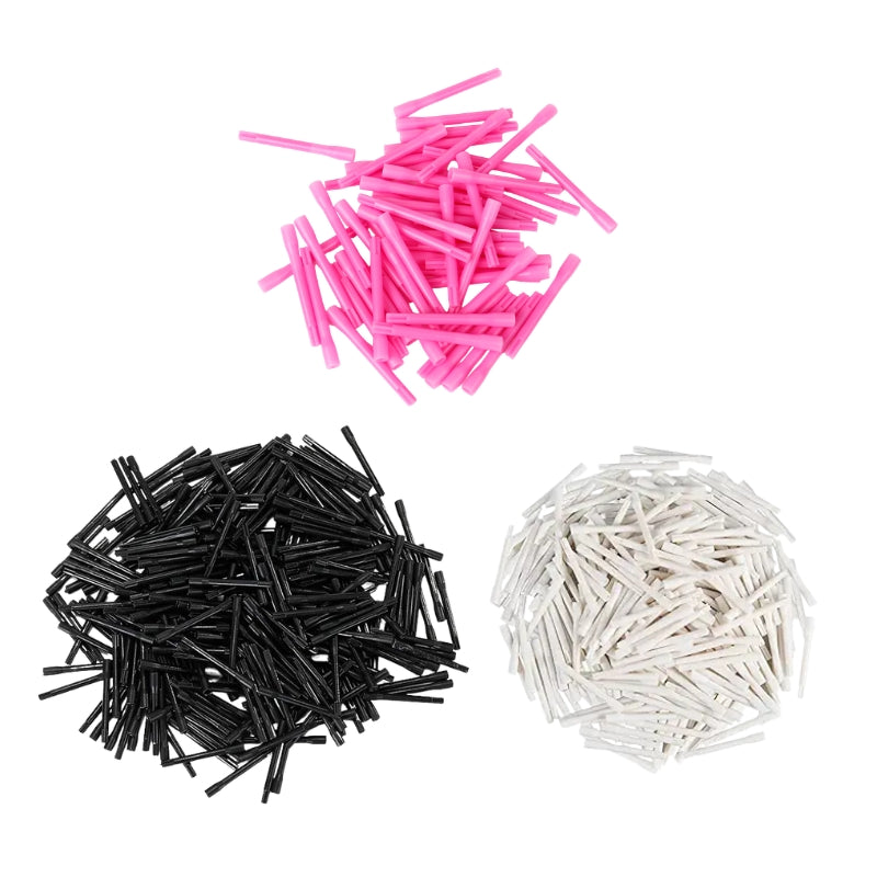 Three piles of Tattoo ink mixer stirring rods in packs of 100 in pink, black, and white colour, arranged on a plain white background.