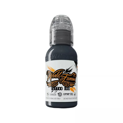 A bottle of World Famous Stonehenge Grey Tattoo Ink in black, featuring a white label with orange and black lettering, and a clear cap, shown on a plain white background.