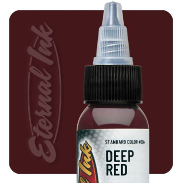 Bottle of Eternal Ink Deep Red tattoo ink on a dark red background