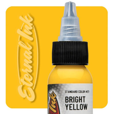 Bottle of Eternal Ink Bright Yellow tattoo ink on a yellow background