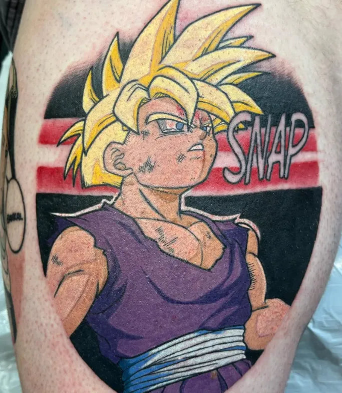 Tattoo of a character with spiky hair and 'SNAP' text on a person's arm.