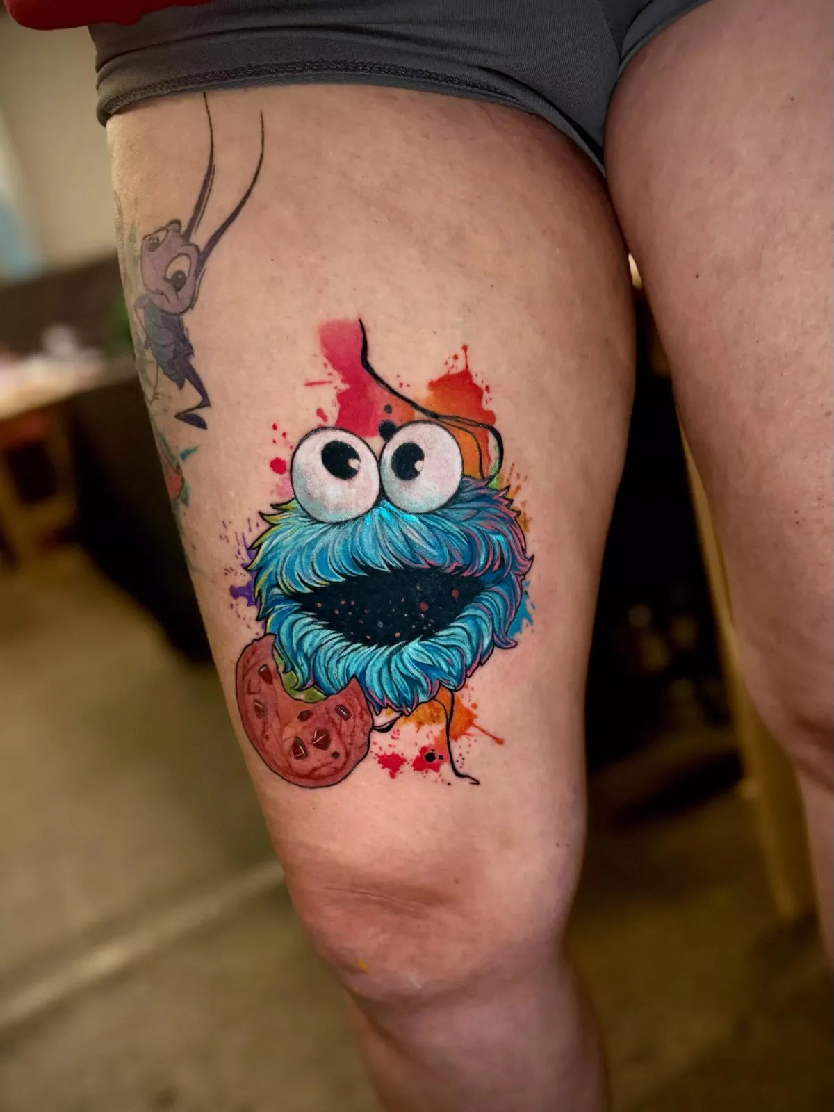 Colorful cartoon character tattoo on a person's leg.