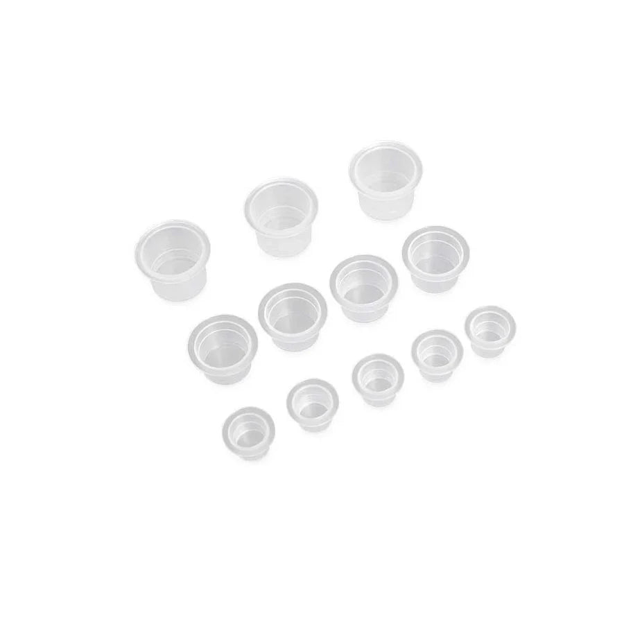 Tattoo ink cups in a white background